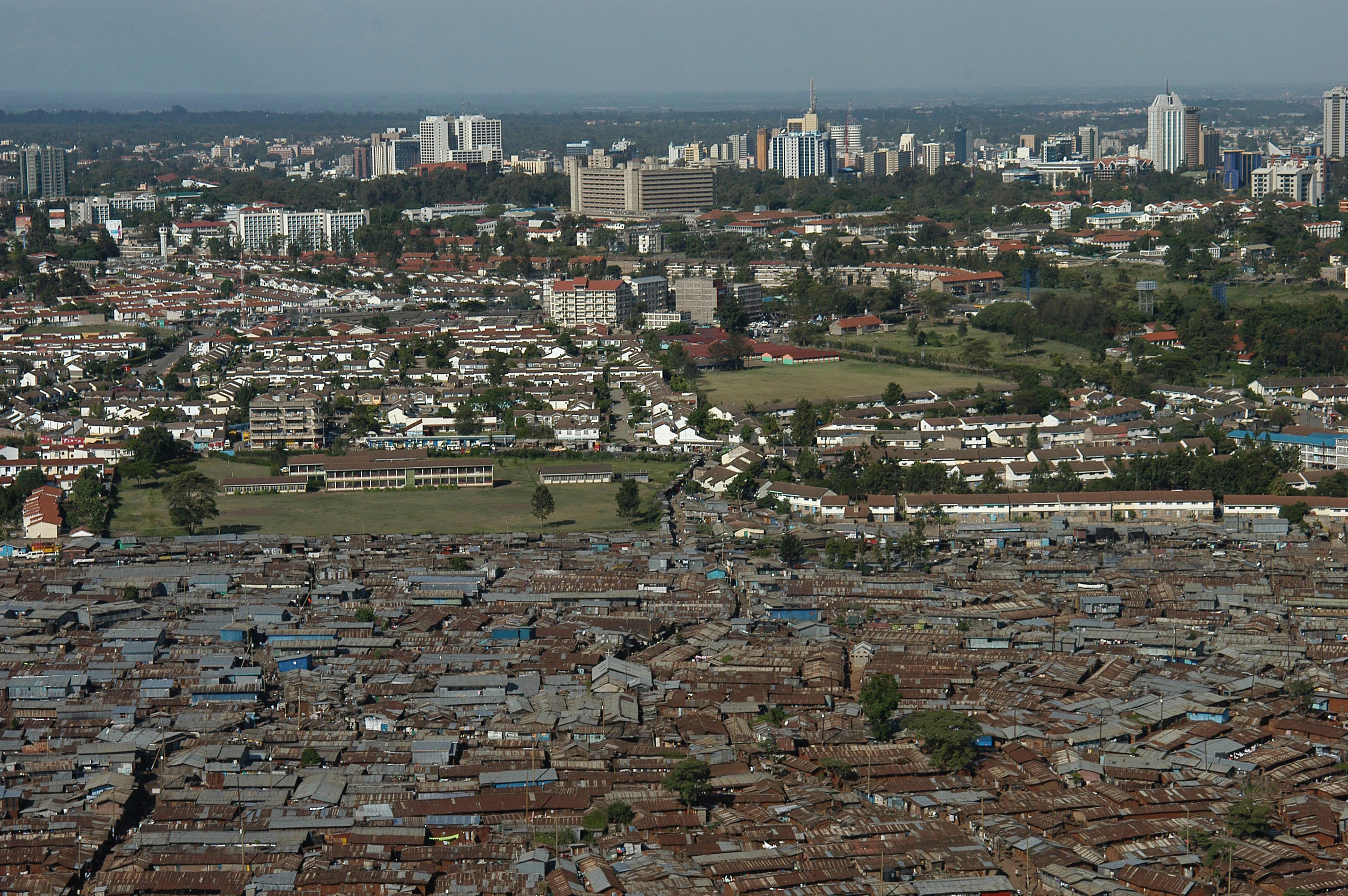 An aerial view of the slum of Kibera with the Nairobi skyline in the background, Kenya.