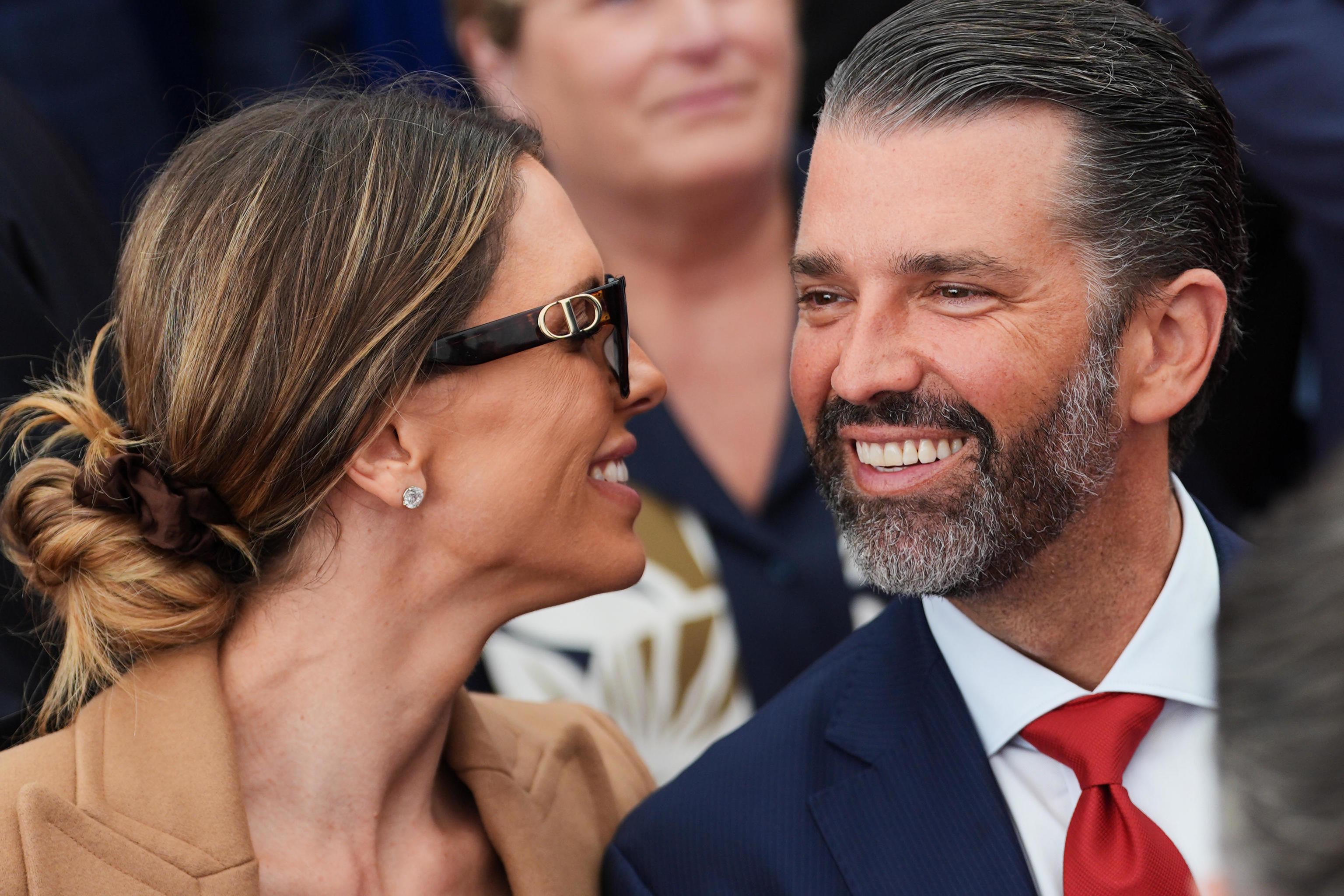 Donald Trump Jr., speaks with his wife Bettina.