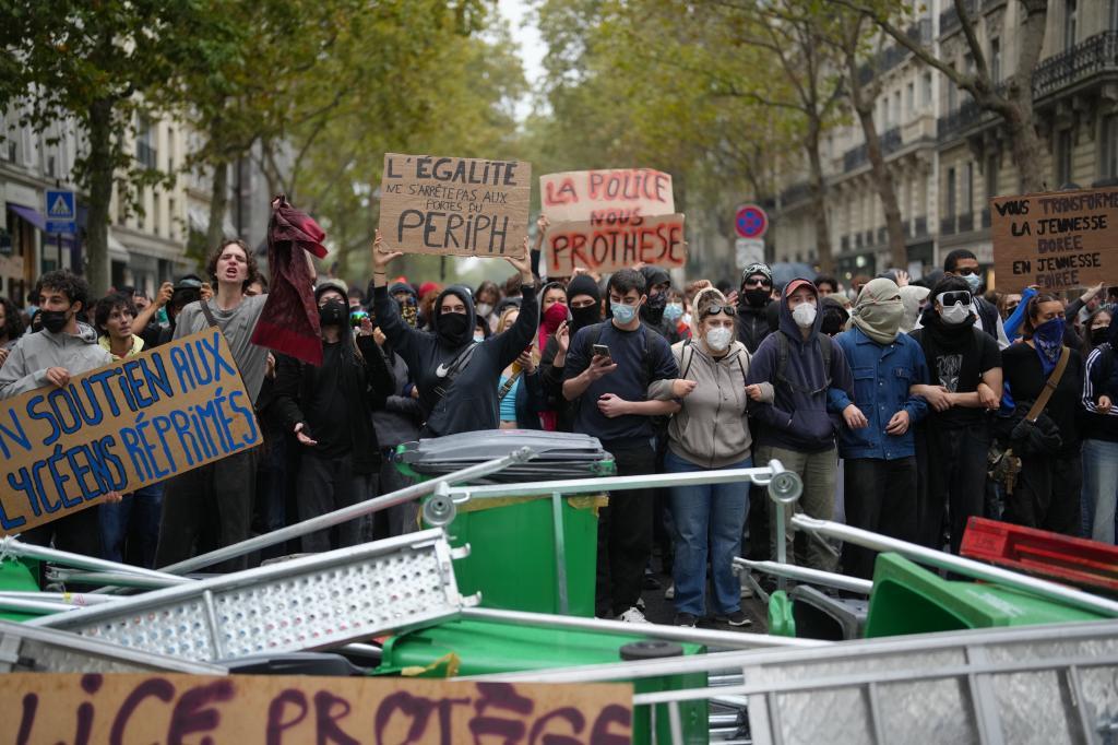 Students stand in front of Sciences Po university as they protest against under-resourced schools,