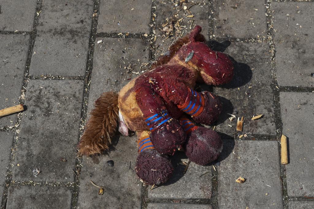 A stuffed horse with bloodstains on it lies on a platform after Russian shelling at the railway station in Kramatorsk