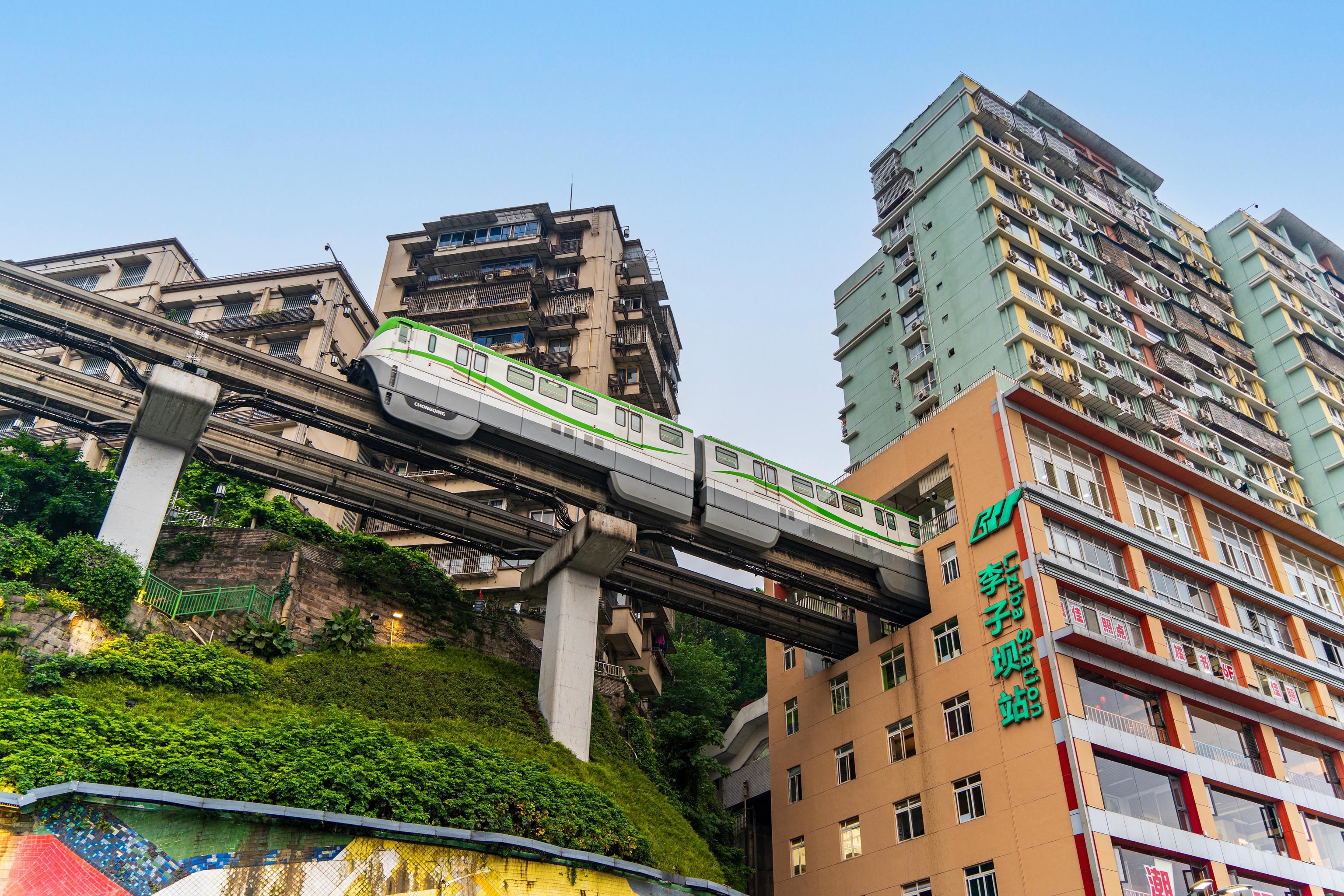 A train from the Chongqing railway system passes through an apartment building in Liziba.