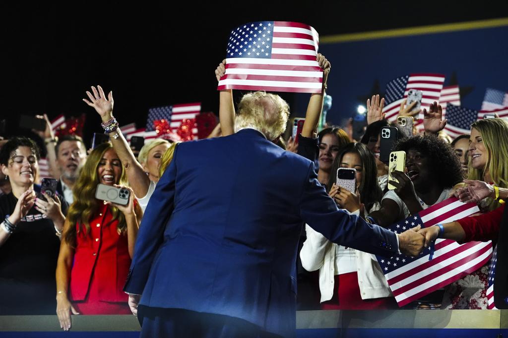 President Donald Trump greets supporters.