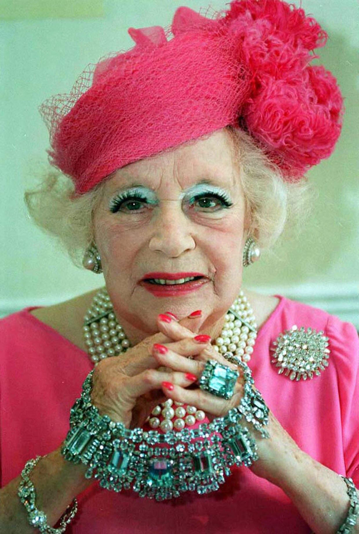 Barbara Cartland with her characteristic pink image with pearls.