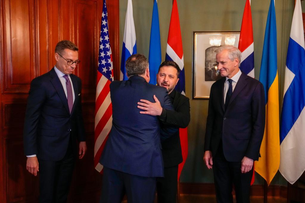 Ukrainian President Volodymyr Zelenskyy, center, hugs U.S. envoy Steve Witkoff