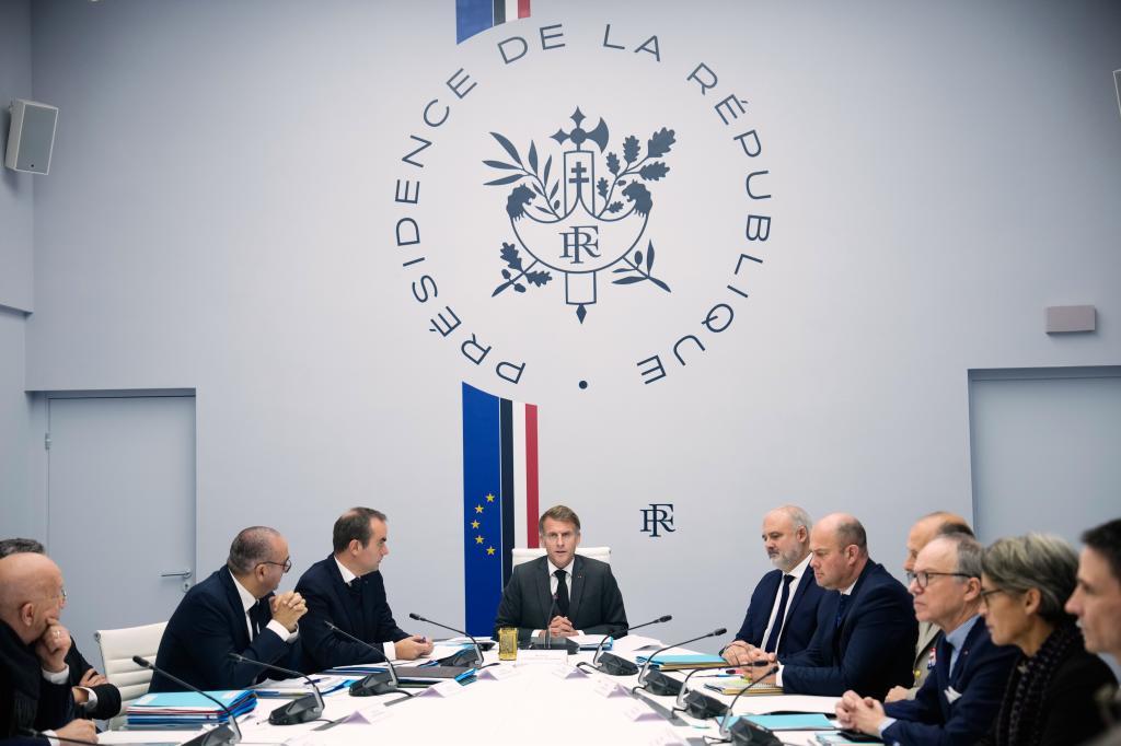 French President Emmanuel Macron, center, attends a security council