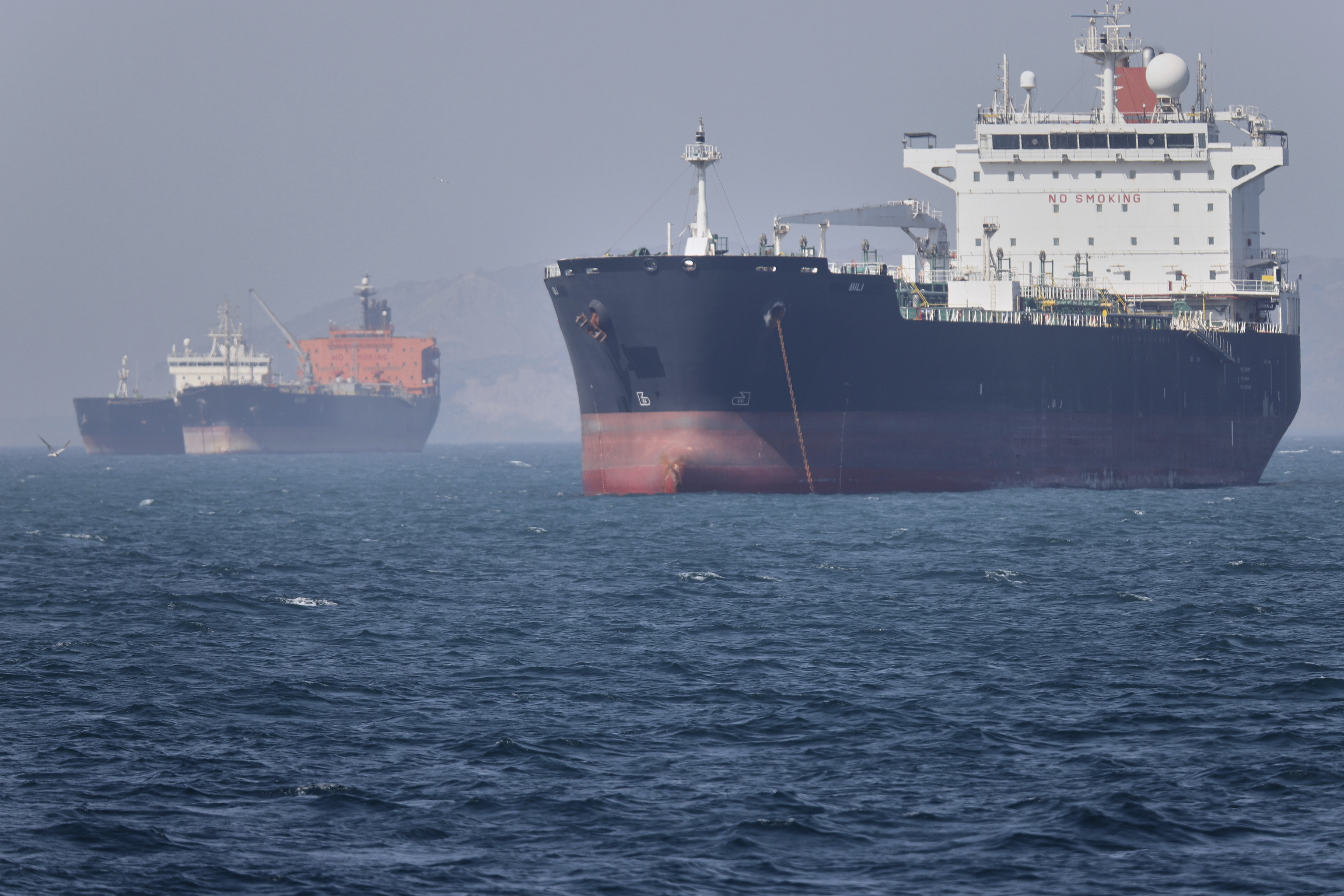 Oil tankers sit at anchor offshore in the Strait of Hormuz.