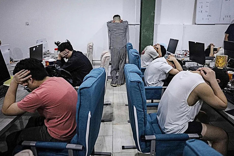 Workers in the scam industry, during a police operation in Laos.