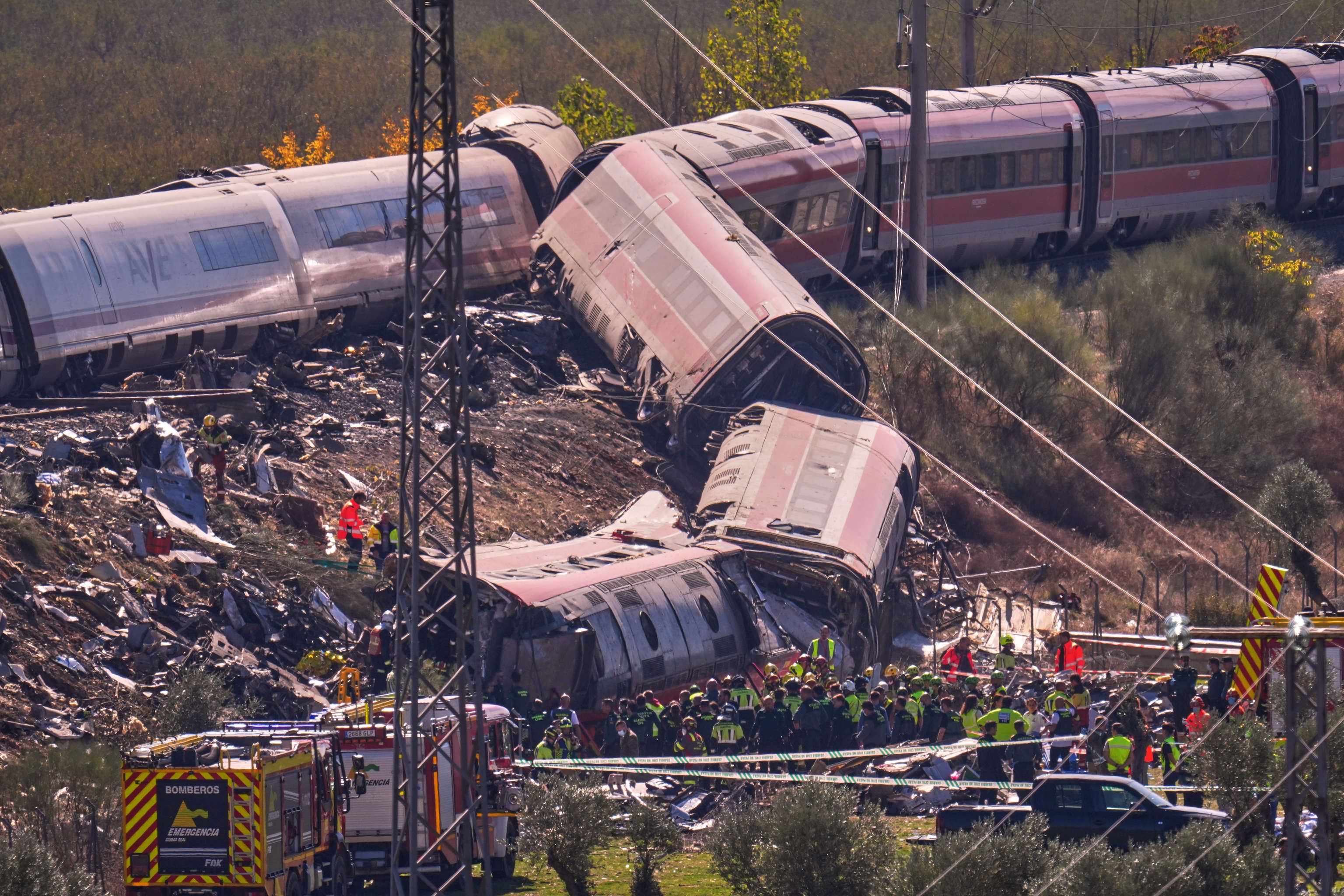 Emergency services work at the scene of a collision between two trains in Urda, Spain.