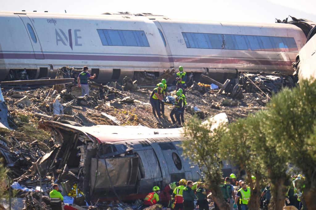 Rescue workers are attending to the victims of a collision between two trains near Urda,