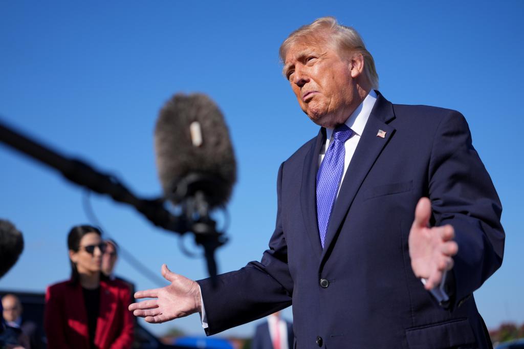 President Donald Trump speaks with reporters before boarding Air Force One