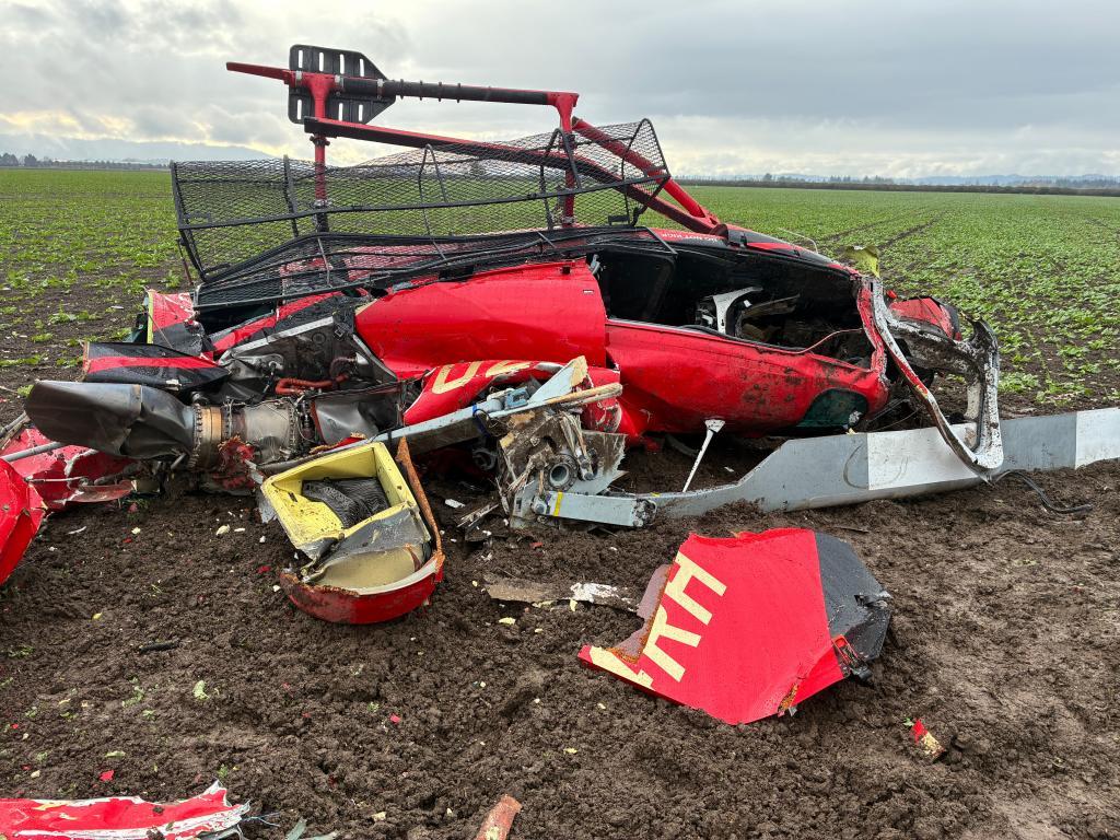 A damaged helicopter after two helicopters collided and crashed into a farm field in Yamhill County